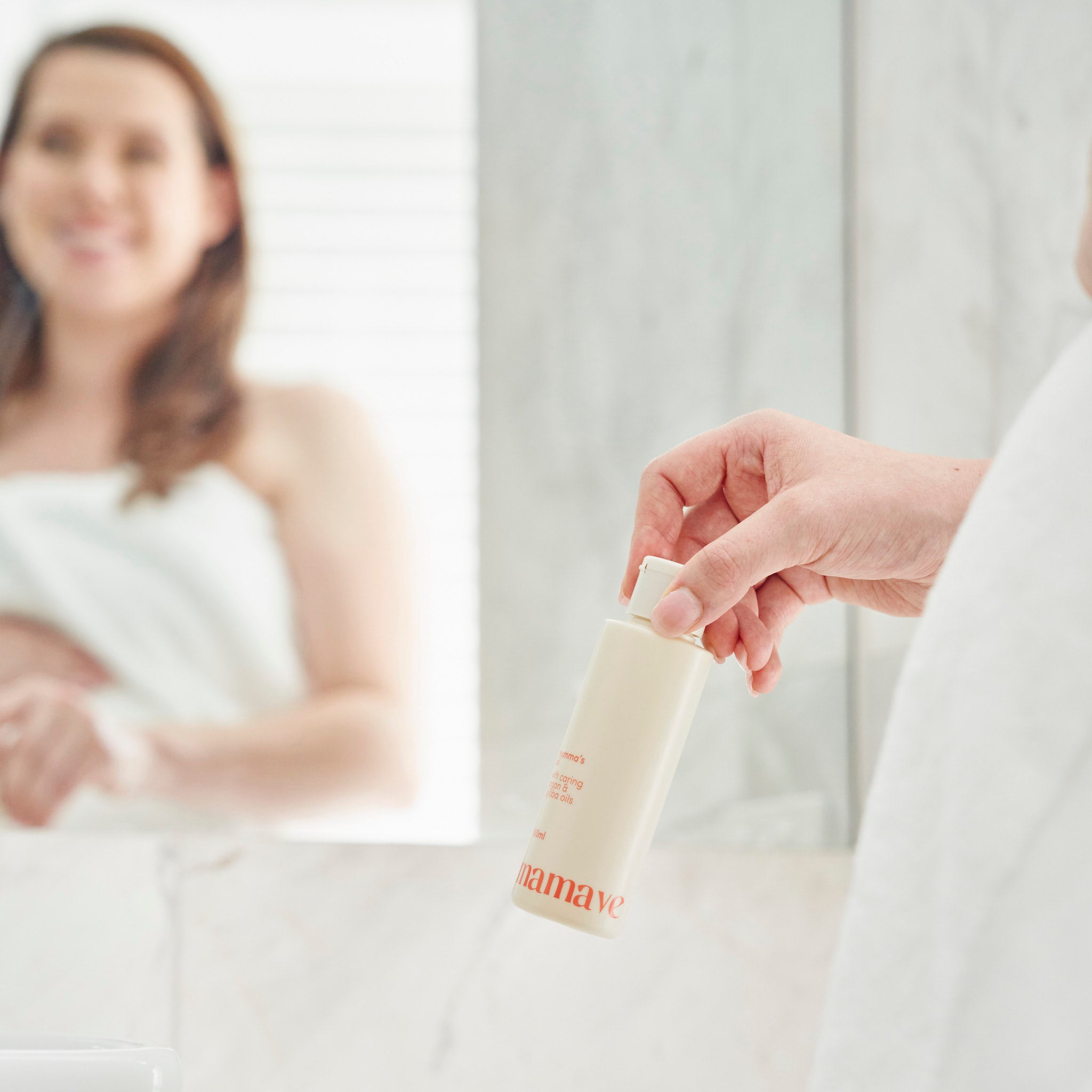 mummas oil held with mum looking in mirror